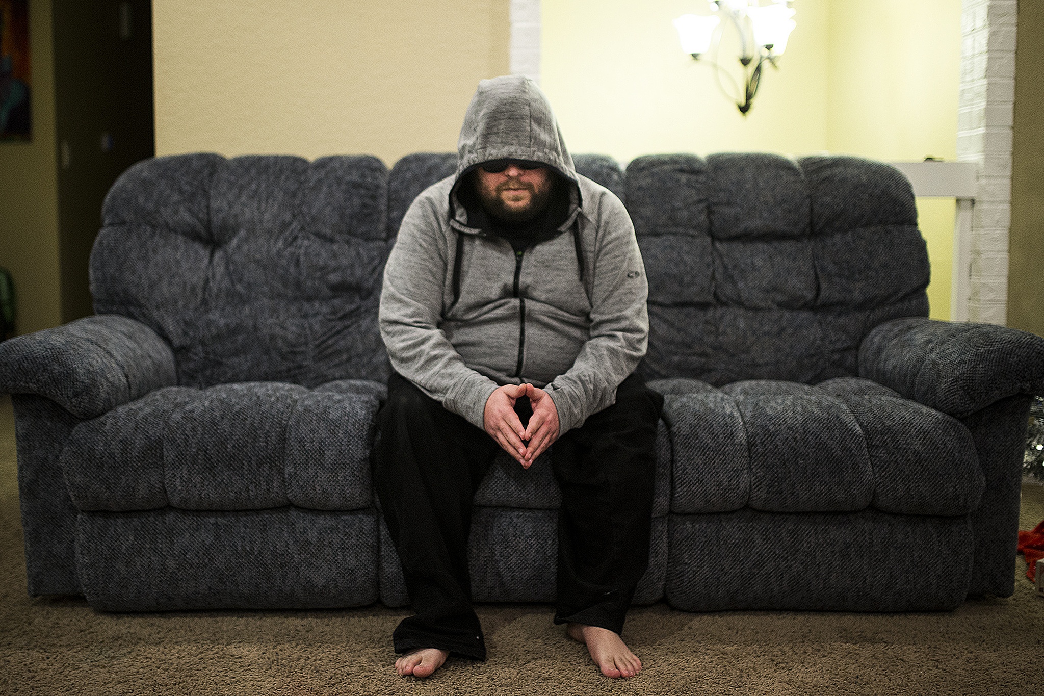 Former Microsoft employee Henry Soto is living with post-traumatic stress disorder linked to his job at the software company, where he was responsible for seeking out and examining “terms of use” violations that often included images of murder, rape and child pornography. He wears a hood and sunglasses to soften his hypersensitive startle response.(Ian Terry / The Herald)