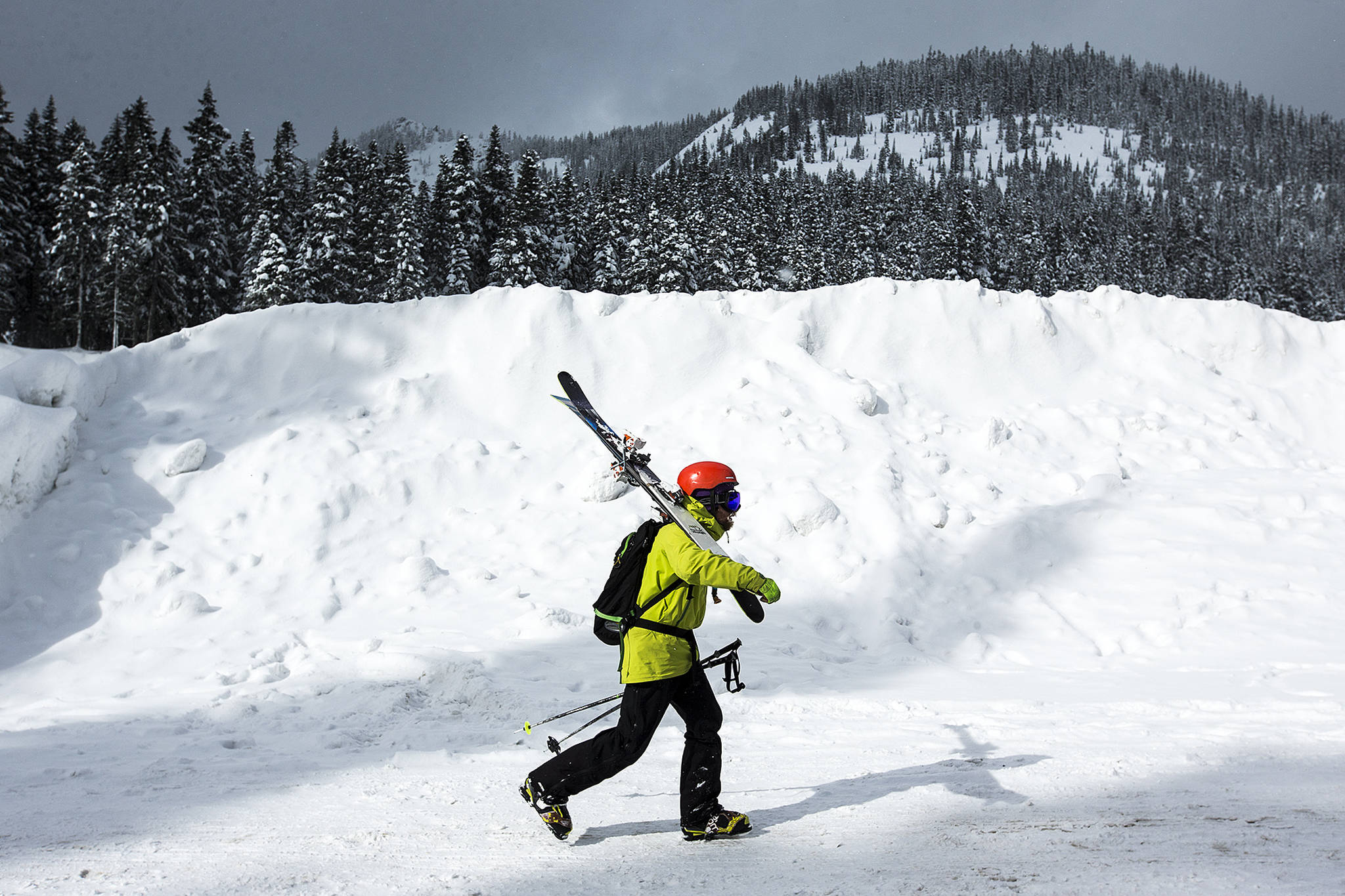 Matt Holland, of Leavenworth, walks through the Stevens Pass parking lot Tuesday following his 29th day on skis this season. “It’s been killer,” Holland said of this year’s ski conditions, “especially after a couple of crummy seasons.” (Ian Terry / The Herald)