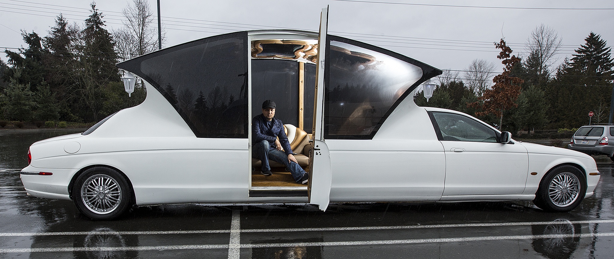 Norlan Nord sits in his converted carriage limousine in a Kirkland parking lot on Wednesday, Feb. 15. Nord did the conversion himself. (Ian Terry / The Herald)