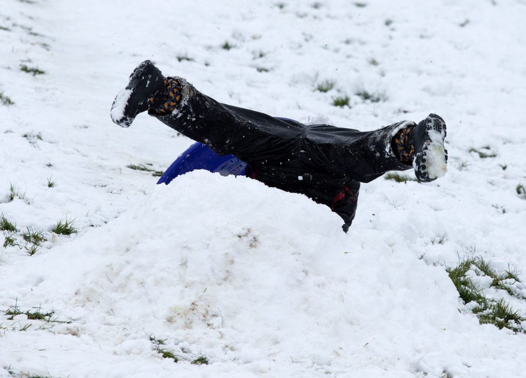 A sledder is inverted as he tries to go over a small jump at Stanwood High School on Monday. (Andy Bronson / The Herald)
A sledder flips after hitting a small jump at Stanwood High School on Monday. (Andy Bronson / The Herald)
