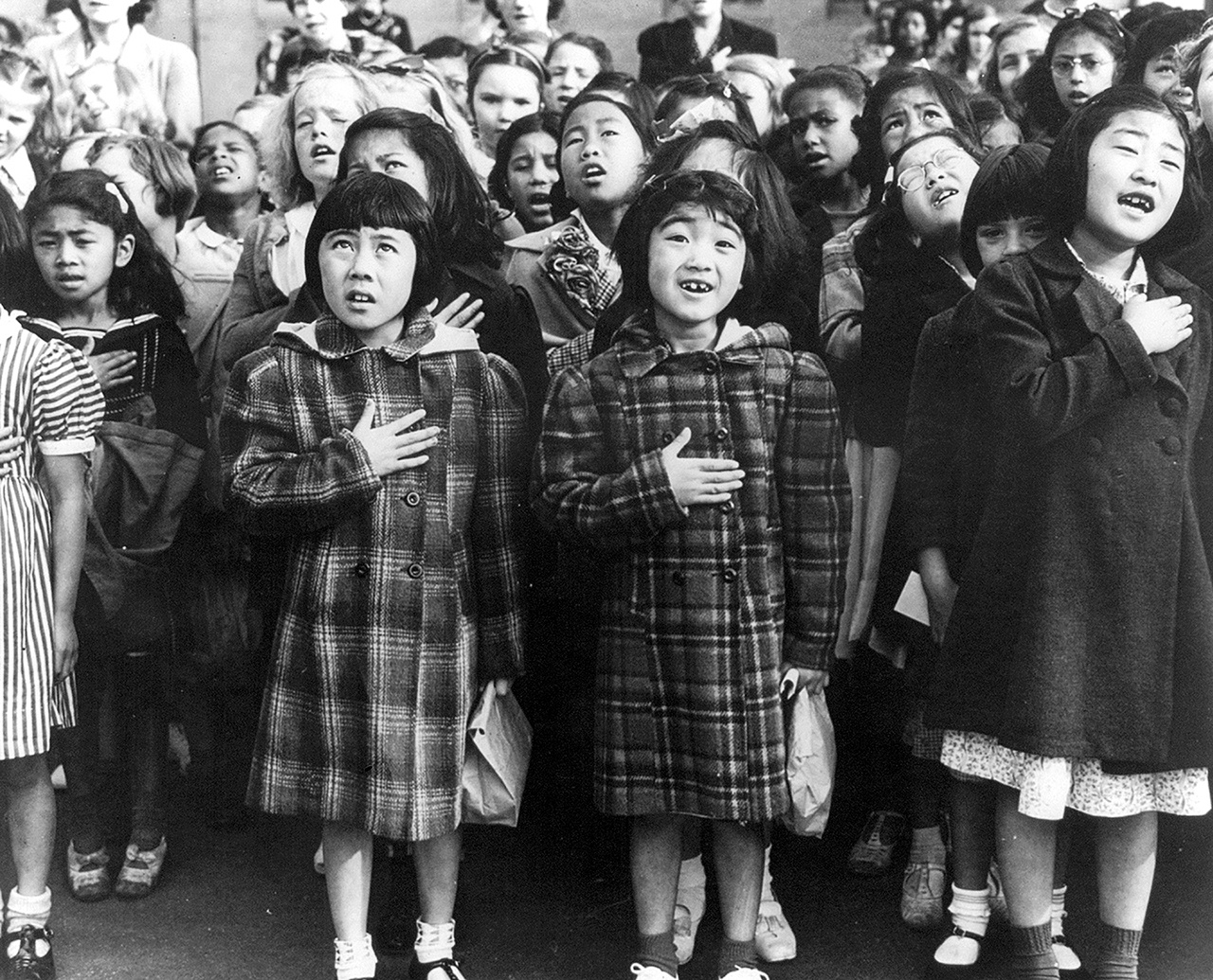 In this April 1942 photo, children at the Weill public school in San Francisco recite the Pledge of Allegiance. Some of them are evacuees of Japanese ancestry who will be housed in War Relocation Authority centers for the duration of the war. Roughly 120,000 Japanese immigrants and Japanese-Americans were sent to camps that dotted the West because the government claimed they might plot against the U.S. (Dorothea Lange/U.S. War Relocation Authority via AP, Library of Congress)