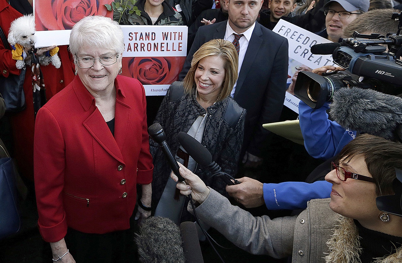In this Nov. 15, 2016, photo, Barronelle Stutzman (left), a Richland florist who was fined for denying service to a gay couple in 2013, smiles as she is surrounded by supporters after a hearing before Washington’s Supreme Court in Bellevue. (AP Photo/Elaine Thompson, File)