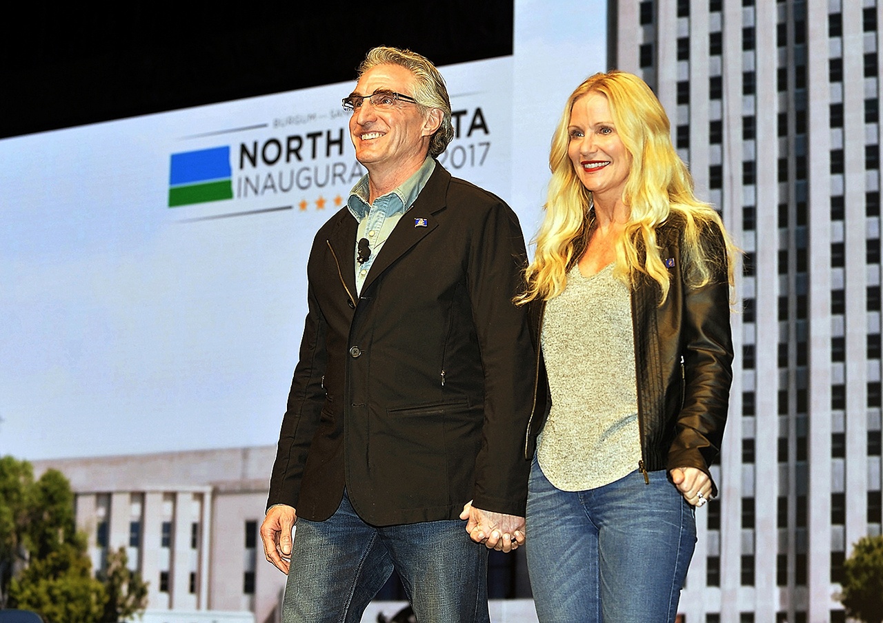 In this Jan. 4 photo, North Dakota Gov. Doug Burgum and first lady Kathryn Helgaas Burgum greet the crowd at the governor’s inauguration celebration in Bismarck, North Dakota. (Will Kincaid/The Bismarck Tribune via AP, File)