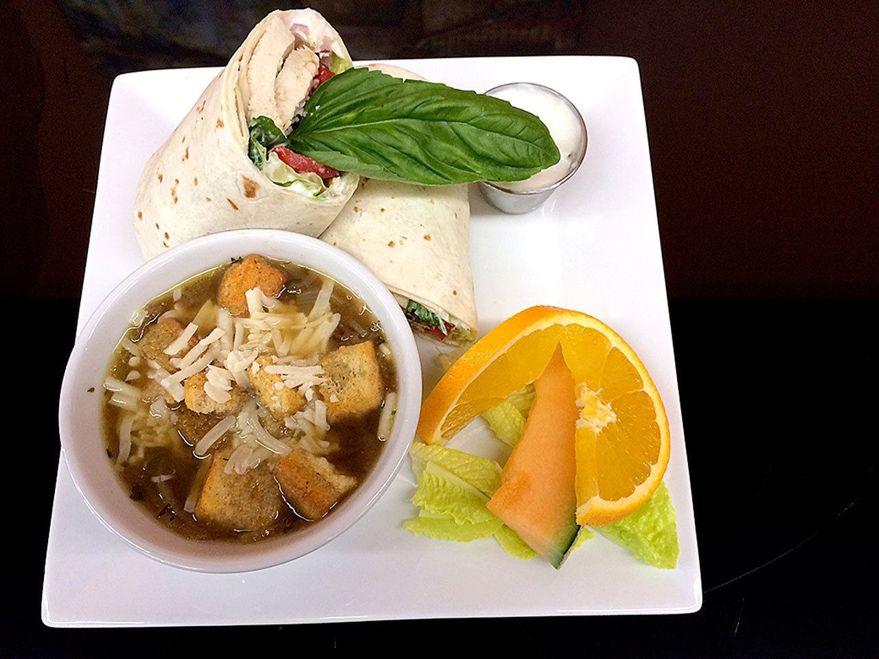 French onion soup and Mediterranean chicken wrap are among the dishes served at Cafe Dijon. Gale Fiege / The Herald