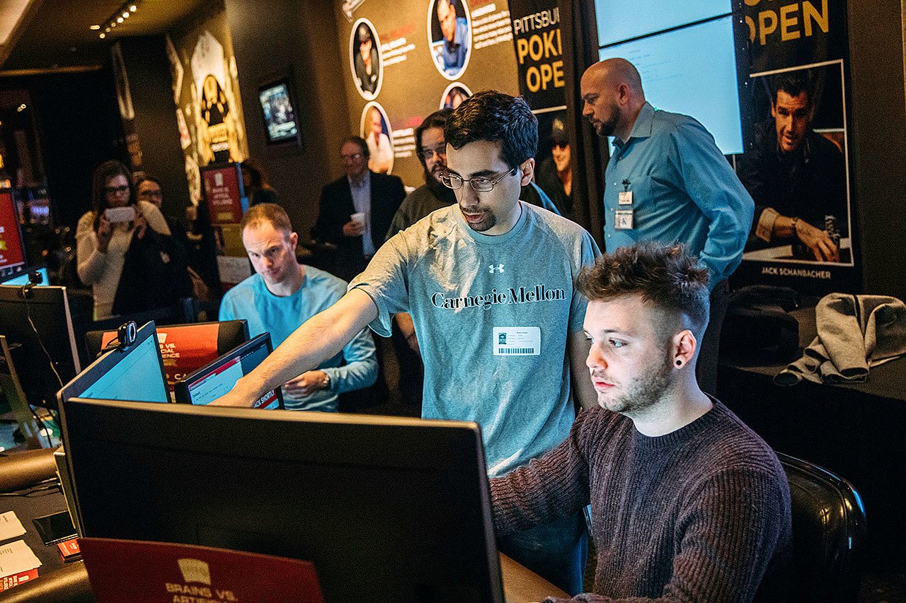 Computer science Ph.D student Noam Brown (center) helps professional poker player, Daniel McAulay, get started during the “Brains Vs. Artificial Intelligence: Upping the Ante” rematch at Rivers Casino on the North Shore in Pittsburgh on Wednesday. (Andrew Rush/Pittsburgh Post-Gazette)