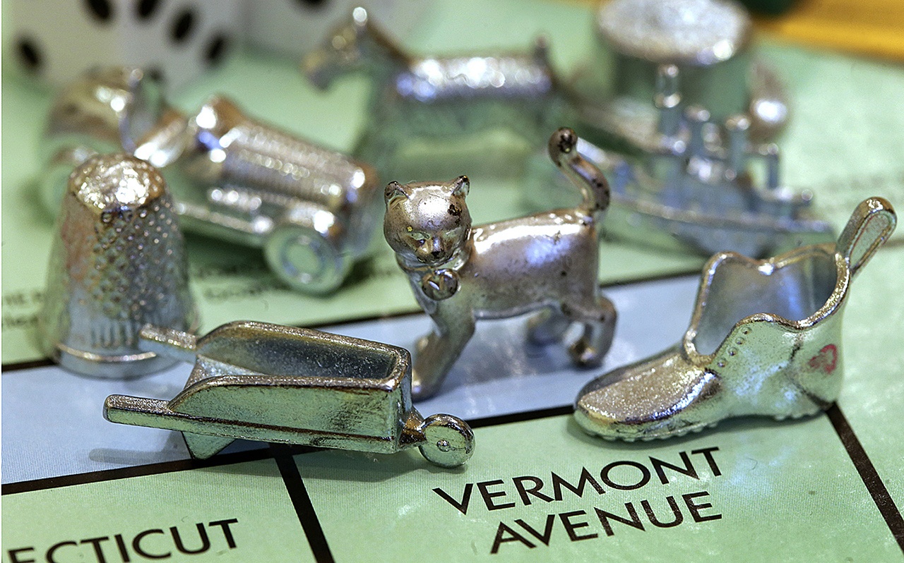 In this 2013 photo, the thimble game piece (left) sits among other Monopoly tokens at Hasbro Inc., headquarters in Pawtucket, Rhode Island. (AP Photo/Steven Senne, File)