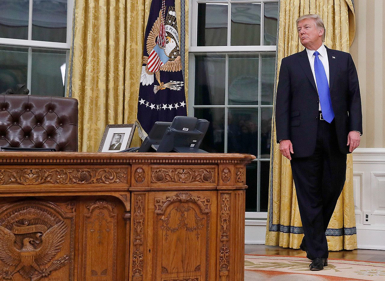 President Donald Trump pauses during a ceremony in Oval Office of the White House in Washington, Wednesday, Feb. 1, 2017, for the swearing in ceremony of Rex Tillerson as Secretary of State. (AP Photo/Carolyn Kaster)