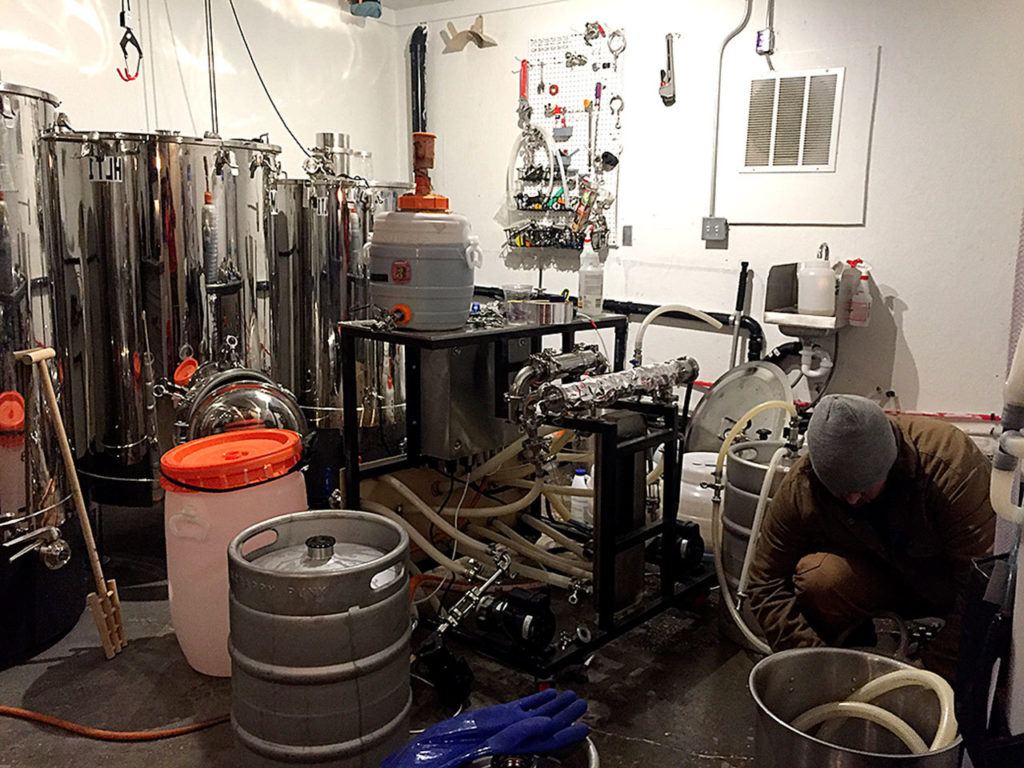 Greg Krsak, owner and head brewer of Scrappy Punk Brewing, works in the brewhouse portion of the brewery in Snohomish.
