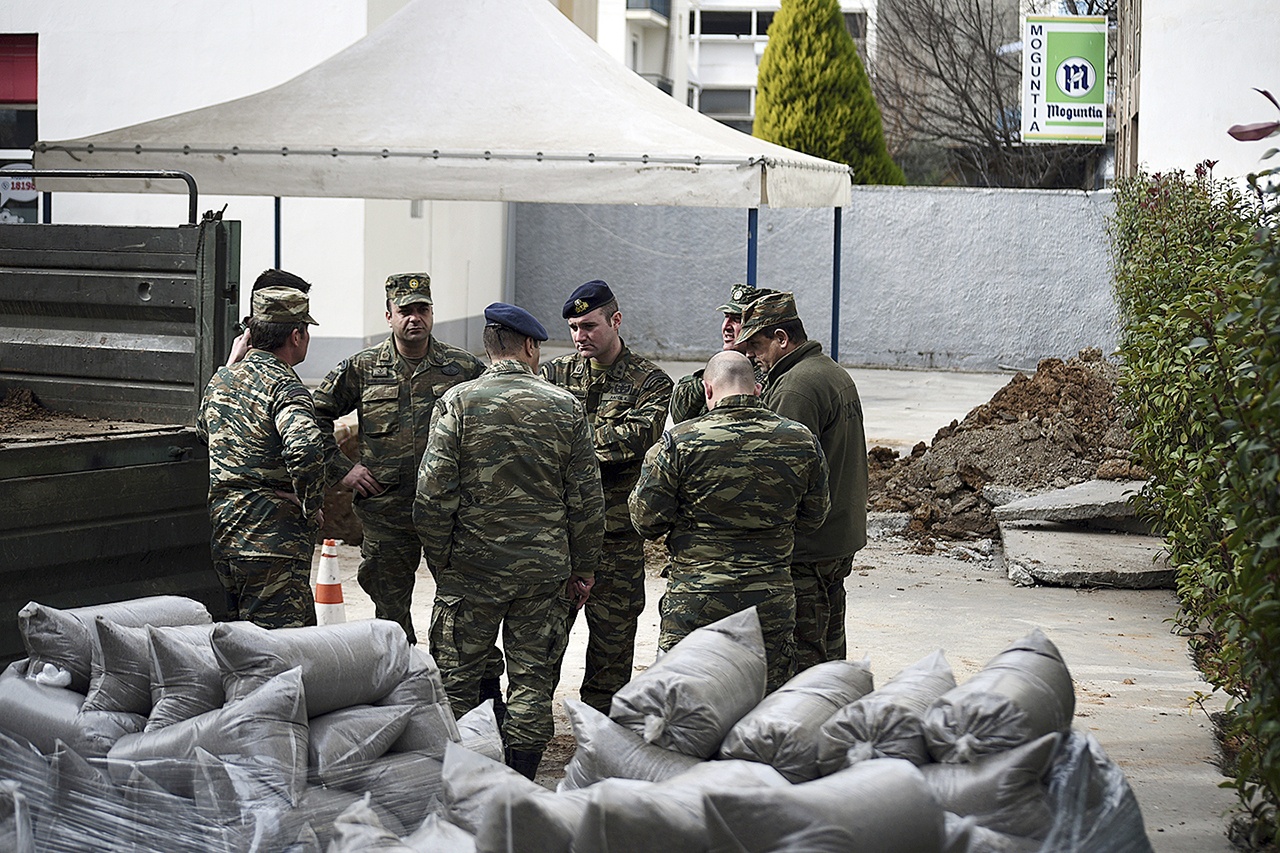 Military officers stand at a gas station in the northern Greek city of Thessaloniki, on Thursday, Feb. 9, where an unexploded World War II bomb was found about 16 feet deep. Authorities in Greece’s second-largest city on Sunday are planning to evacuate up to 75,000 residents from their homes so experts can safely dispose of the unexploded World War II bomb. (AP Photo/Giannis Papanikos)