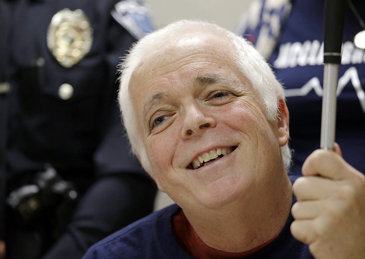 Mount Vernon police officer Michael McClaughry smiles during a news conference shortly before his discharge Tuesday, Feb. 14, at Harborview Medical Center in Seattle. McClaughry was blinded when shot while on duty nearly two months earlier and was discharged from the hospital on Valentine’s Day, his 39th wedding anniversary. (AP Photo/Elaine Thompson)