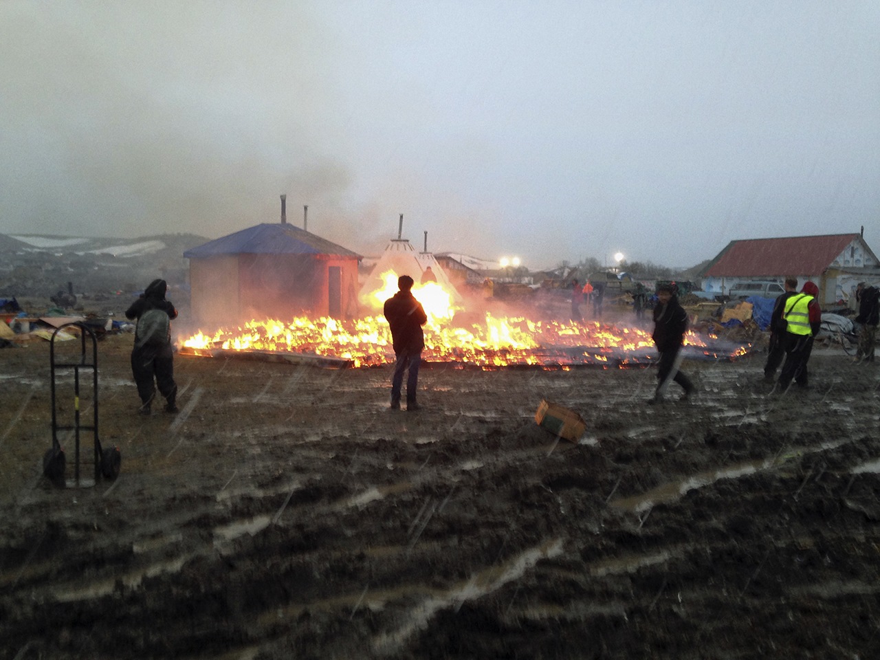 Dakota Access pipeline opponents burn structures in their main protest camp in southern North Dakota near Cannon Ball, North Dakota, on Wednesday, Feb. 22, as authorities prepare to shut down the camp in advance of spring flooding season. (AP Photo/James MacPherson)