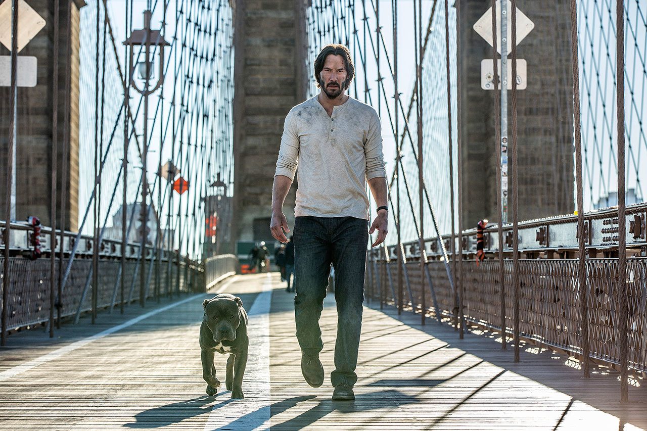 Keanu Reeves takes his new dog for a walk in “John Wick: Chapter 2.” (Lionsgate)