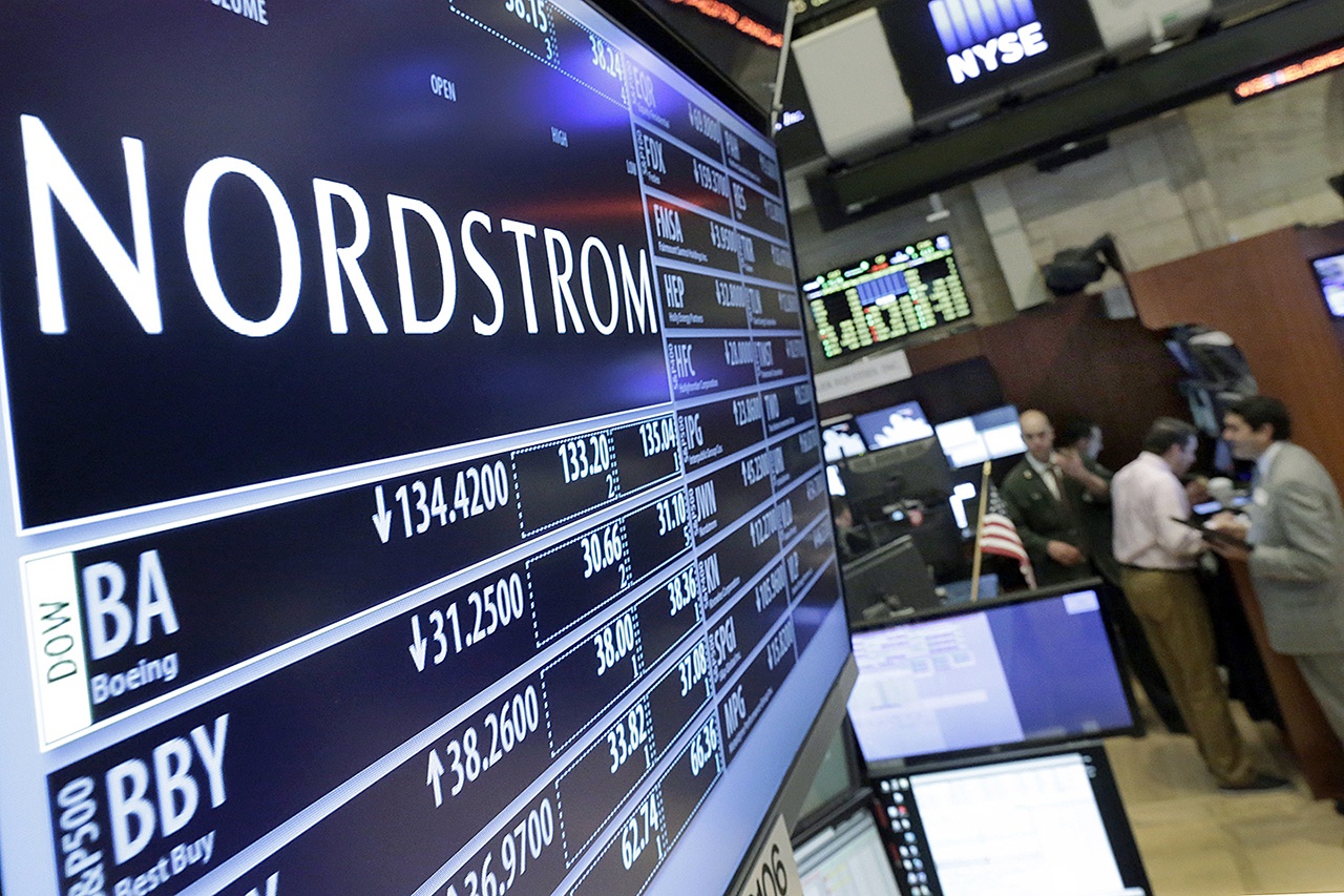 In this 2016 photo, the Nordstrom logo is displayed above the post where it trades on the floor of the New York Stock Exchange in New York. (AP Photo/Richard Drew, File)