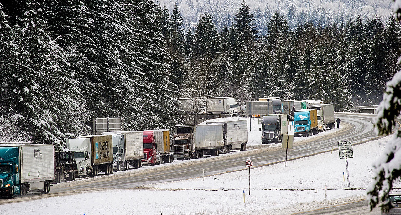 In this Feb. 6 photo, I-90 was closed between North Bend and Ellensburg, causing several miles of backed-up traffic at Exit 34. Three mountain passes, including I-90, remain closed Thursday due to avalanche danger. (Mike Siegel/The Seattle Times via AP, file)