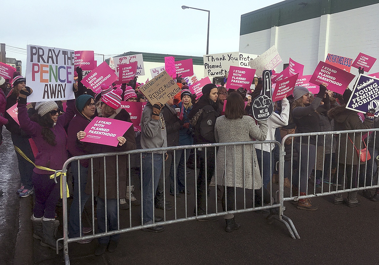 Supporters of Planned Parenthood hold counter protest as abortion opponents demonstrate outside Planned Parenthood in St. Paul, Minnesota, on Saturday, Feb. 11. Rallies aimed at urging Congress and President Donald Trump to end federal funding for Planned Parenthood are scheduled across the country. (AP Photo/Jeff Baenen)