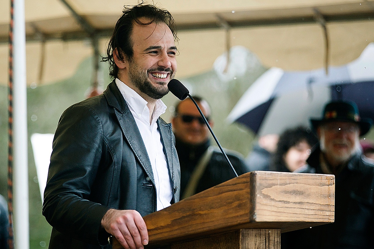 Moayad Adham speaks about his journey as a Syrian immigrant at an immigration rights rally Sunday in front of the state Capitol in Salem, Oregon. Adham thanked the many people who had helped him along the way and continue to help him today. (Molly J. Smith/Statesman-Journal via AP)