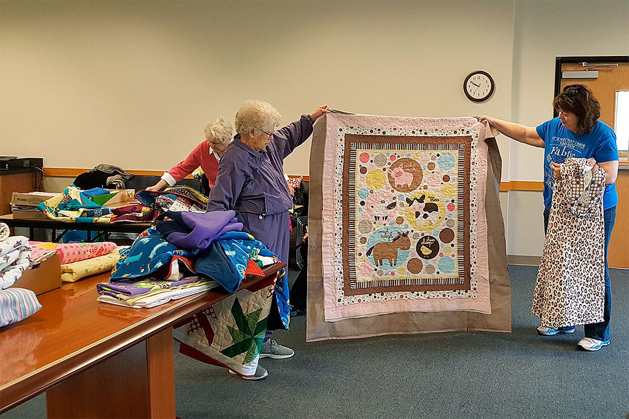 Wrap Them In Love, a local quilting group, donates quilts to a variety of local causes. (Contributed photo)
