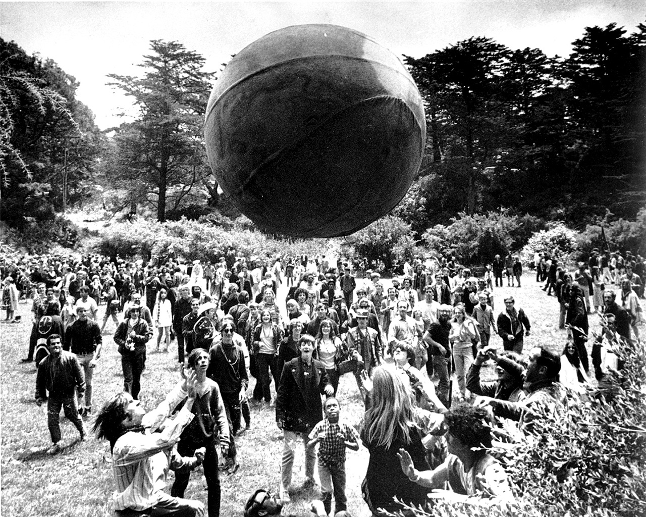 In this June 21, 1967, photo, a crowd of hippies keep a large ball, painted to represent a world globe, in the air during a gathering at Golden Gate Park in San Francisco, to celebrate the summer solstice on June 21, day one of “Summer of Love.” (AP Photo, File)