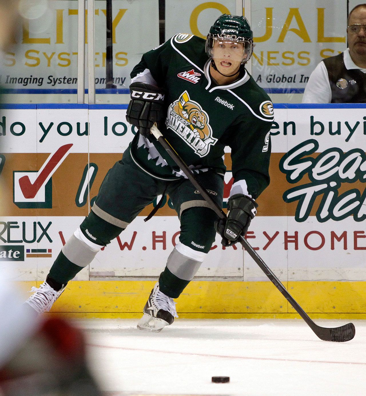 Former Silvertip Tyler Maxwell passes off to a teammate during a game in 2011. Maxwell returned to Everett this past Saturday to take part in Silvertips Alumni Night. (Jennifer Buchanan / The Herald)