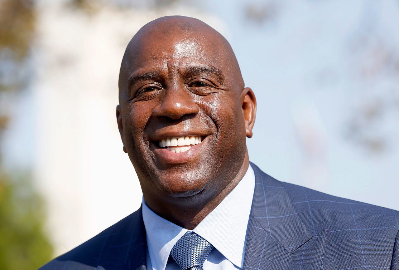 Former Lakers star Magic Johnson (pictured) was put in charge of basketball operations for the team after Los Angeles fired general manager Mitch Kupchak on Tuesday. (AP Photo/Nick Ut)