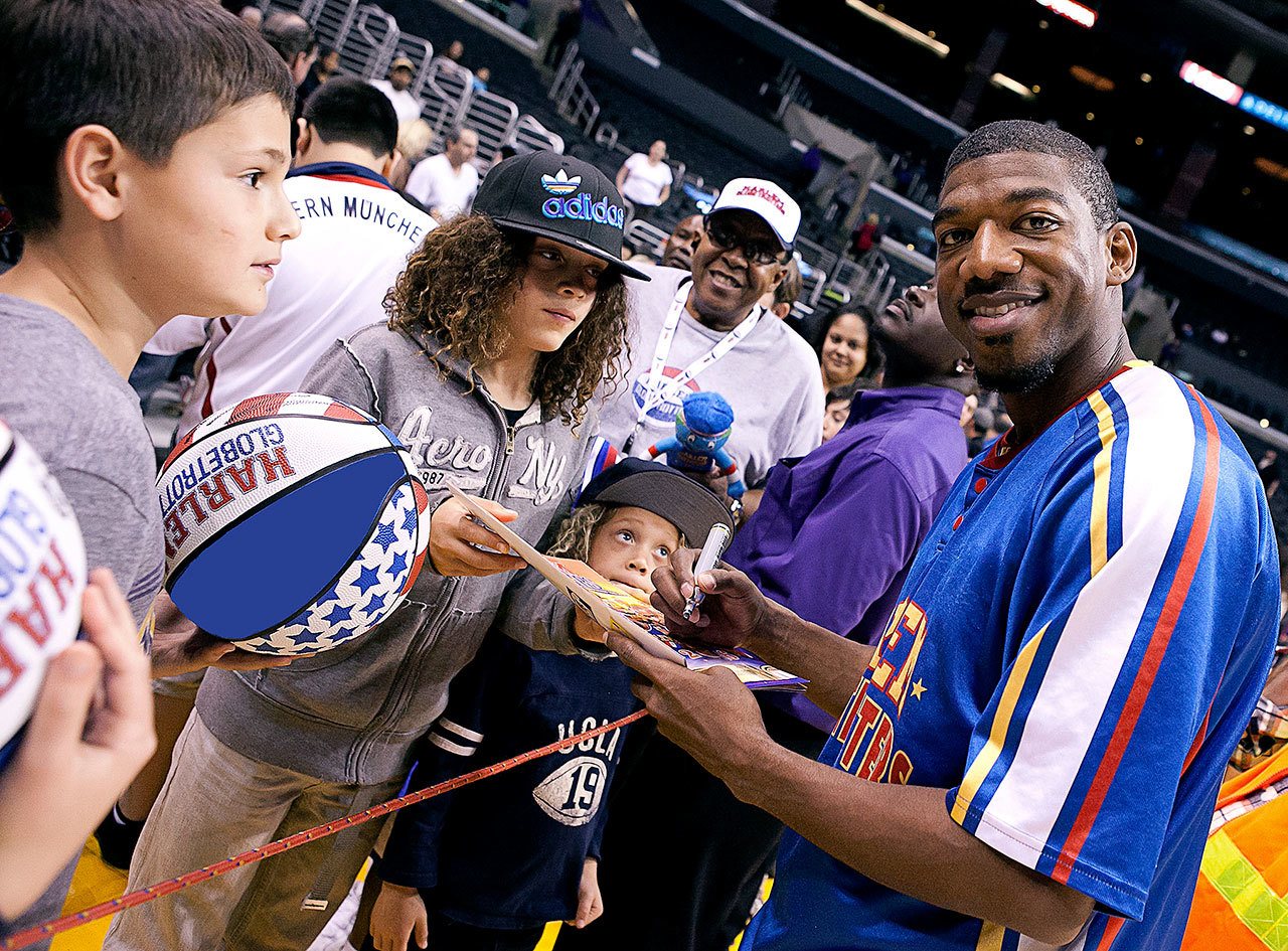 Anthony “Buckets” Blakes, a 15-year veteran of the Harlem Globetrotters, signs autographs. The Globetrotters perform Feb. 19 in Everett.
