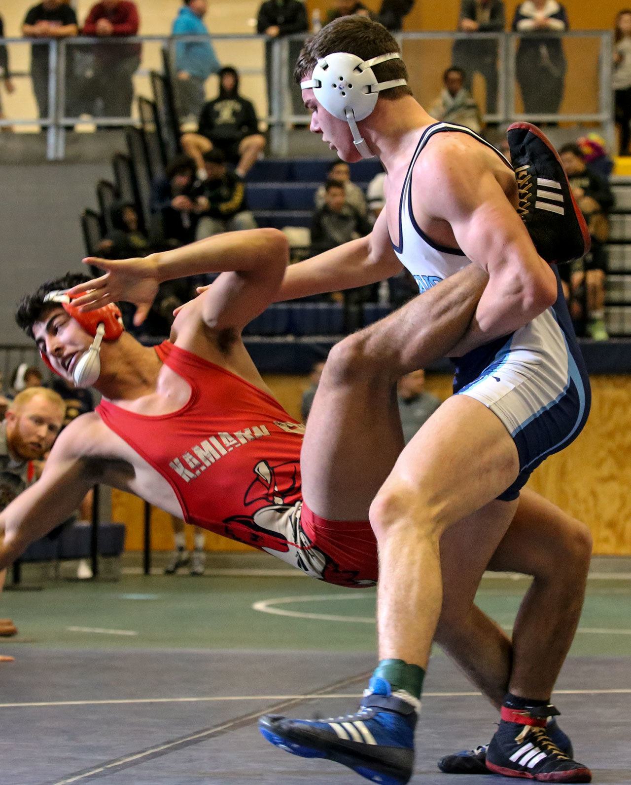 Zach Borisch of Kamiakin wrestles Meadowdale’s Liam Ball on the second day of the 3A regional wrestling tournament Saturday afternoon at Everett High School. (Kevin Clark / The Herald)