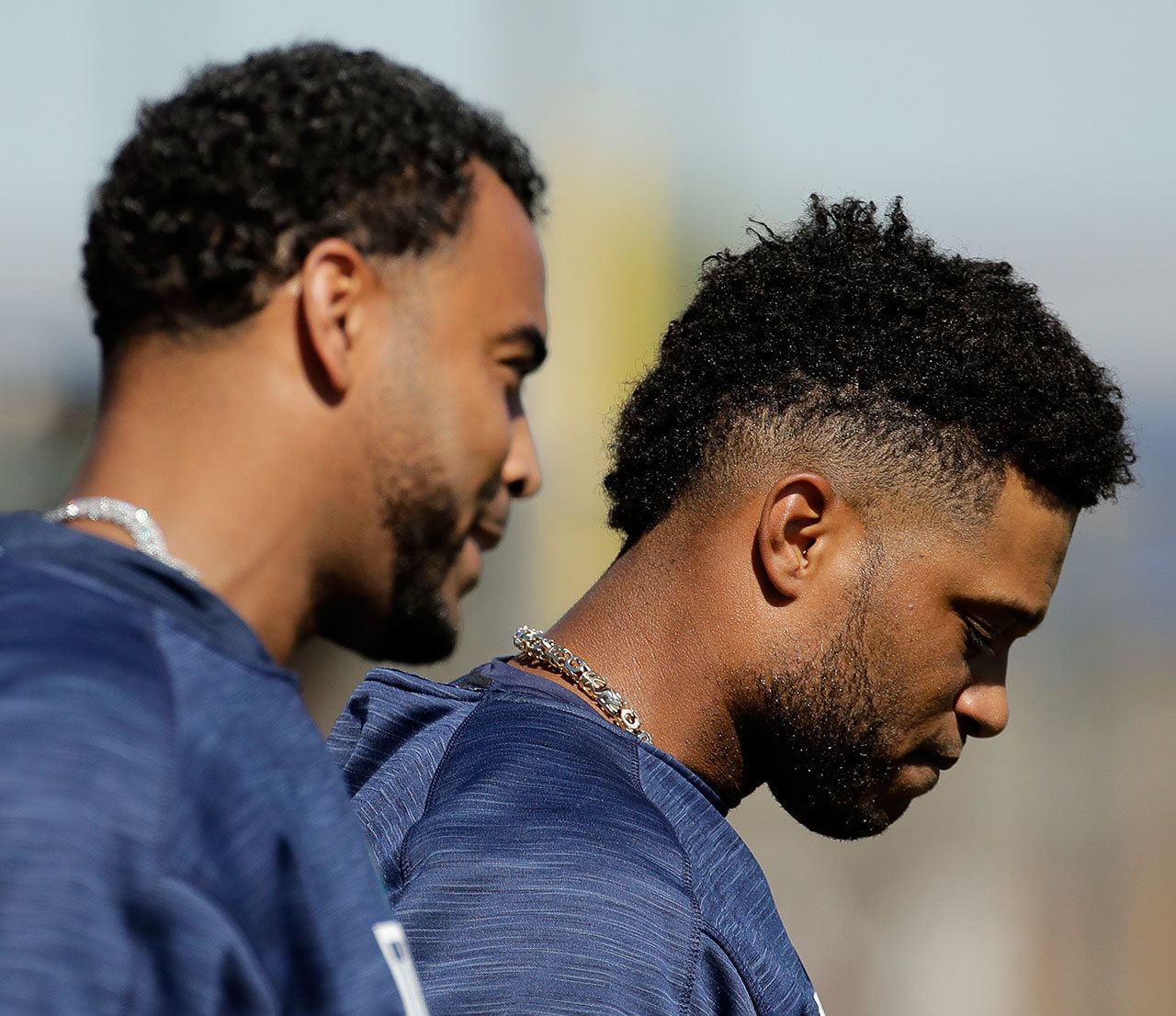 The Mariners’ Nelson Cruz (left) and Robinson Cano walk to a drill during spring training Feb. 21, 2017, in Peoria, Ariz. (AP Photo/Charlie Riedel)