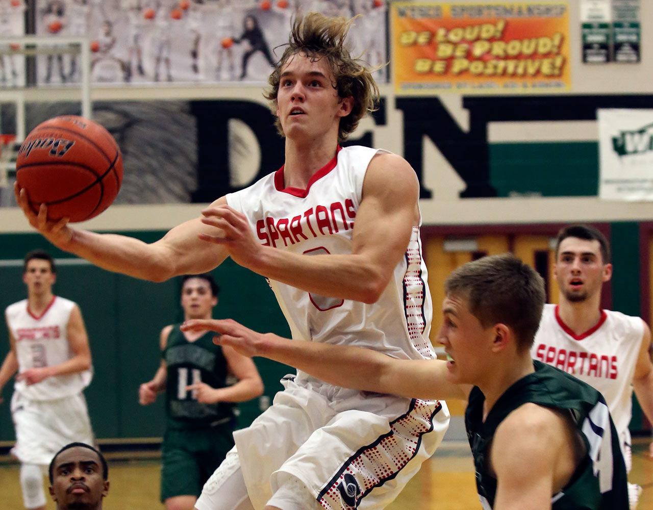 Stanwood’s AJ Martinka attempts a shot past Edmonds-Woodway’s Ryan Peterson Wednesday night at Henry M. Jackson in Everett on February 15, 2017. (Kevin Clark / The Herald)