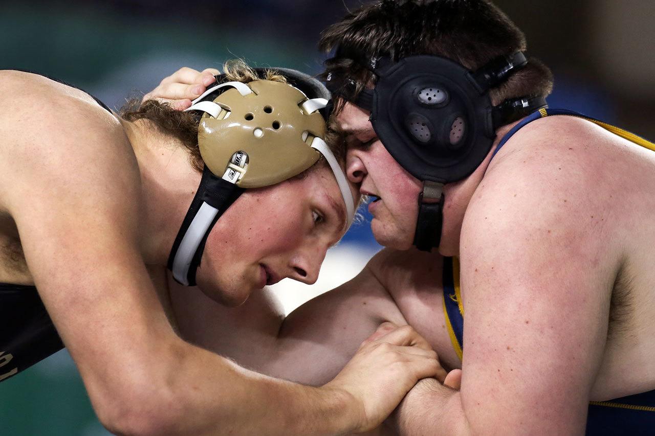 Oak Harbor’s Samuel Zook (left) and Arlington’s Tristen Emery wrestle in the 285-pound championship match at Mat Classic XXIX on Feb. 18, 2017, in Tacoma. (Kevin Clark / The Herald)