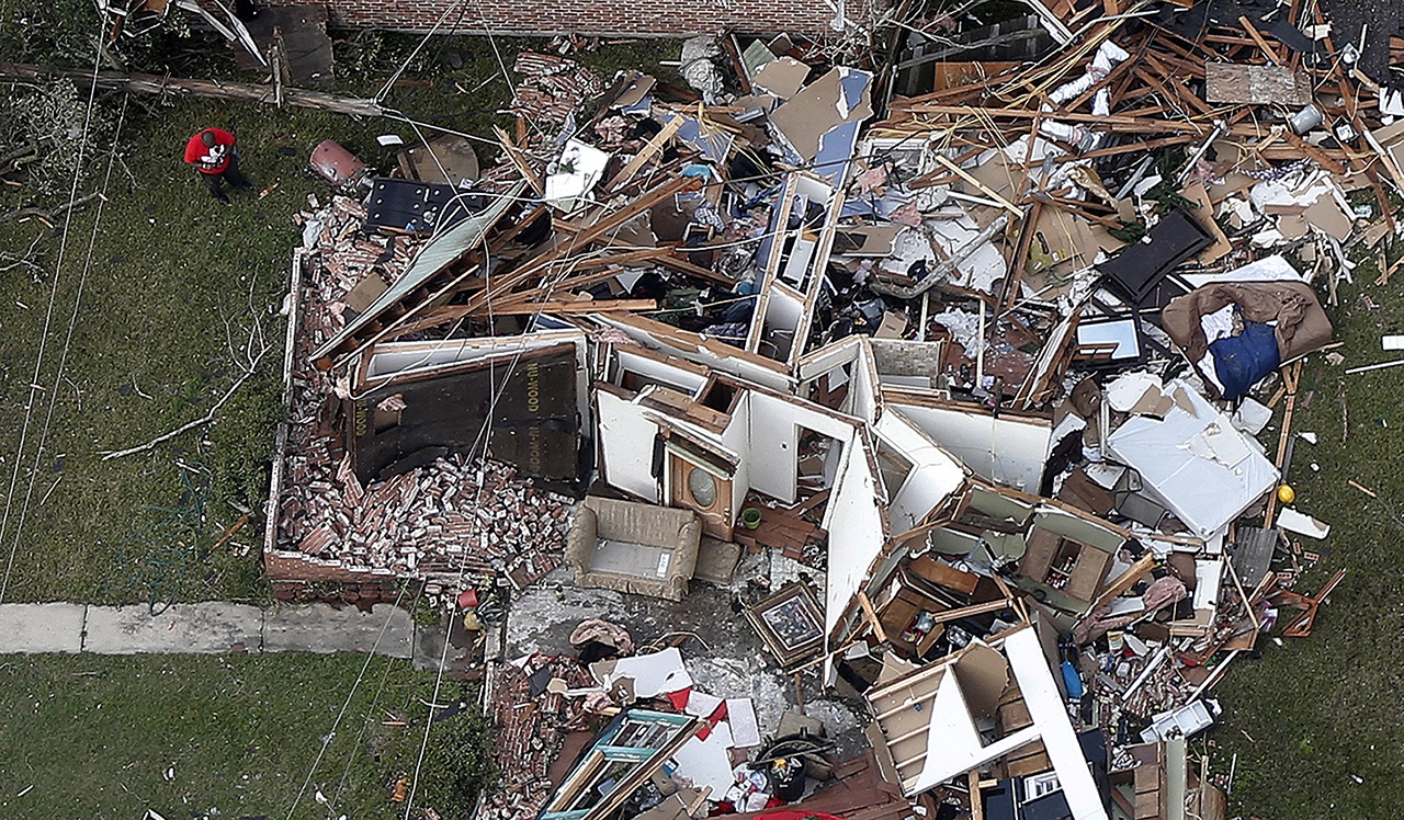 A man stands next to a destroyed home after a tornado tore through the eastern neighborhood of New Orleans on Tuesday, Feb. 7. (AP Photo/Gerald Herbert)