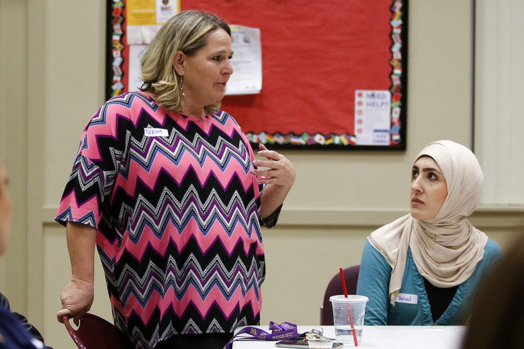 Teena Ellison (left) talks as friend and fellow Everett community member Shehed Al-Azadi listens during an informal meeting at Pineview Community Center in Everett on Thursday. (Ian Terry / The Herald)
