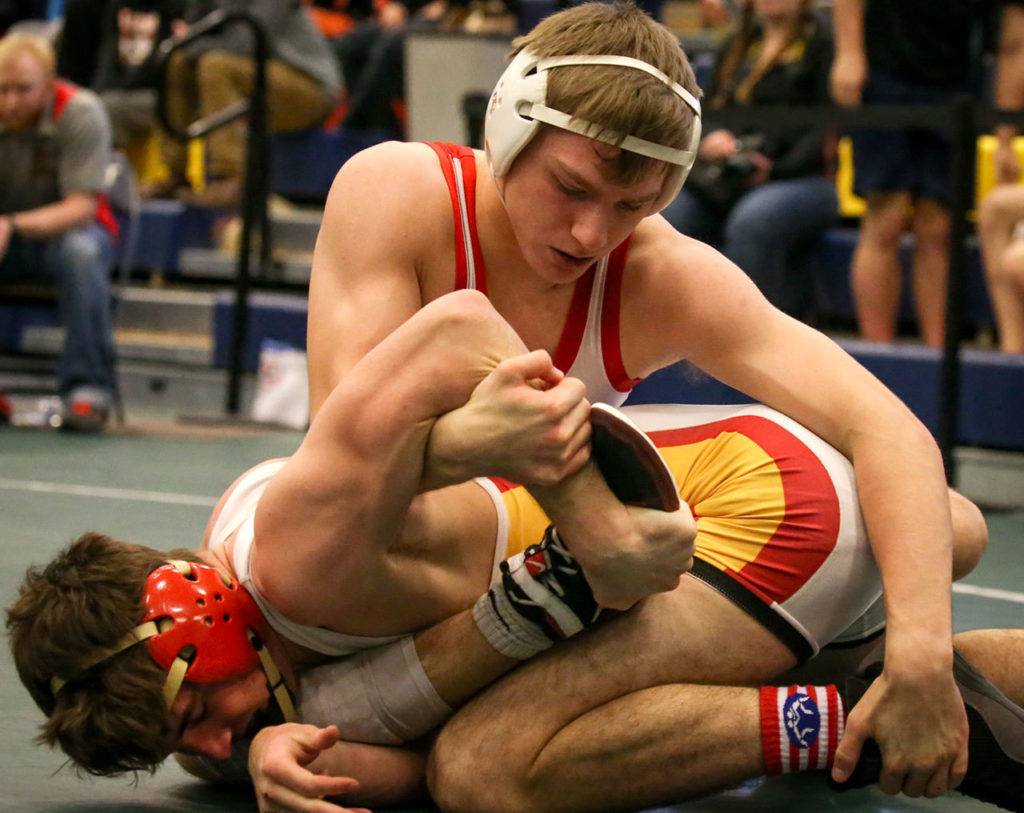 Stanwood’s Mason Phillips (top) wrestles Kamiakin’s Liam Walker in a 145-pound match Feb. 11 at the 3A Region 3 Tournament at Everett High School. Phillips won 19-4. (Kevin Clark / The Herald)
