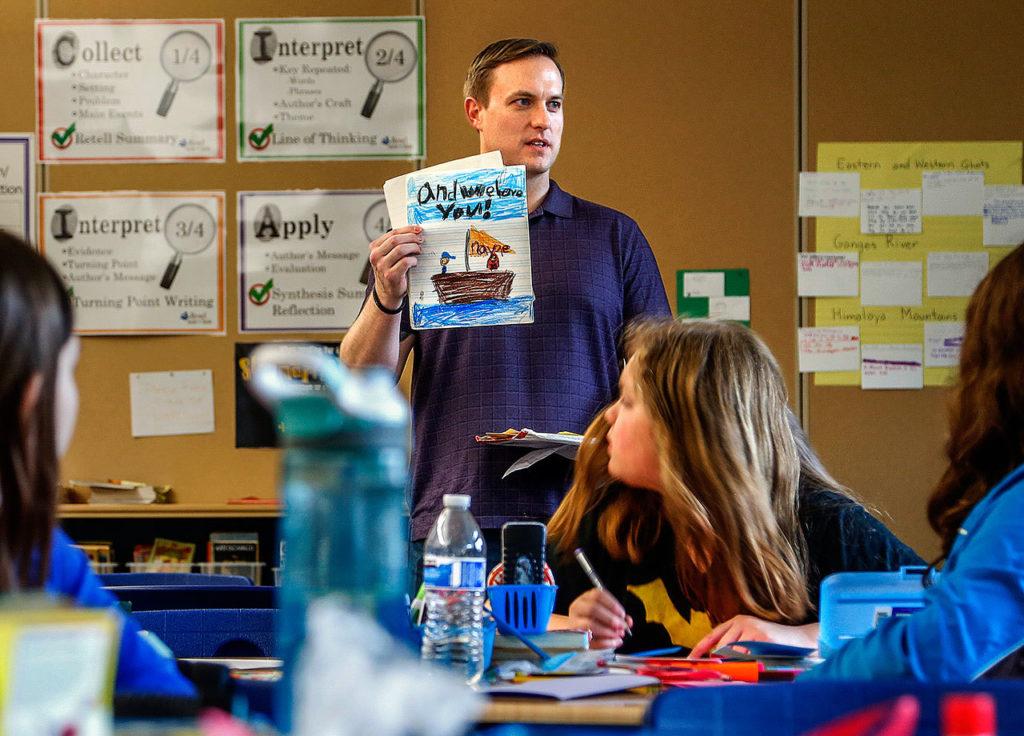 A Wounded Warrior Fellow with U.S. Rep. Suzan DelBene’s office, Benjamin Studley, 37, talks to students at Machias Elemenary School before picking up Valentine cards they made for veterans at the VA Puget Sound hospital in Seattle. Here, Studley, who attended Machias Elementary himself, shows students a few of the cards he received from Machias Elementary students while he served aboard a ship in the United States Navy. (Dan Bates / The Herald)
