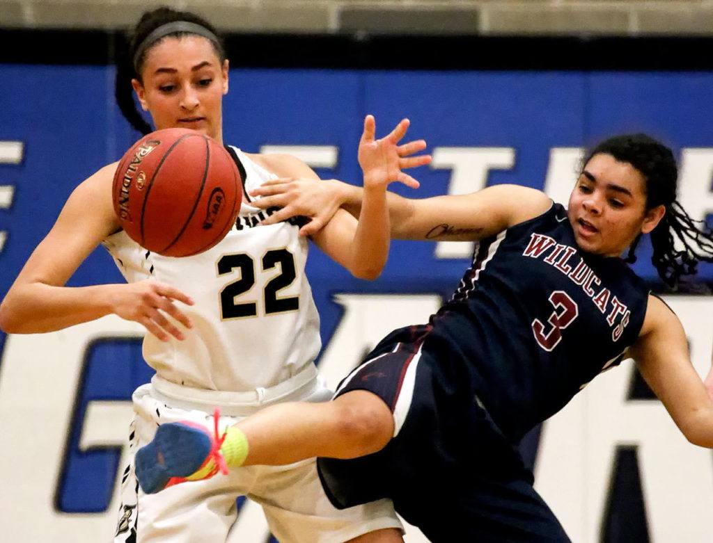 Lynnwood’s Kaprice Boston (left) and Mt. Spokane’s Jaidyn Lyman vie for a loose ball during a regional playoff game Feb. 25, 2017, at Bothell High School. Lynnwood won 57-46. (Kevin Clark / The Herald)
