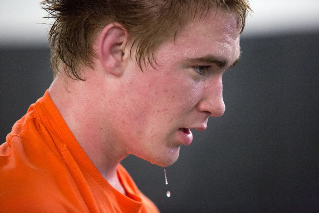 Sweat drips from the chin of Marysville Getchell wrestler Michael Stewart as he watches teammates during practice on Feb. 8, 2017 in Marysville. (Andy Bronson / The Herald)
