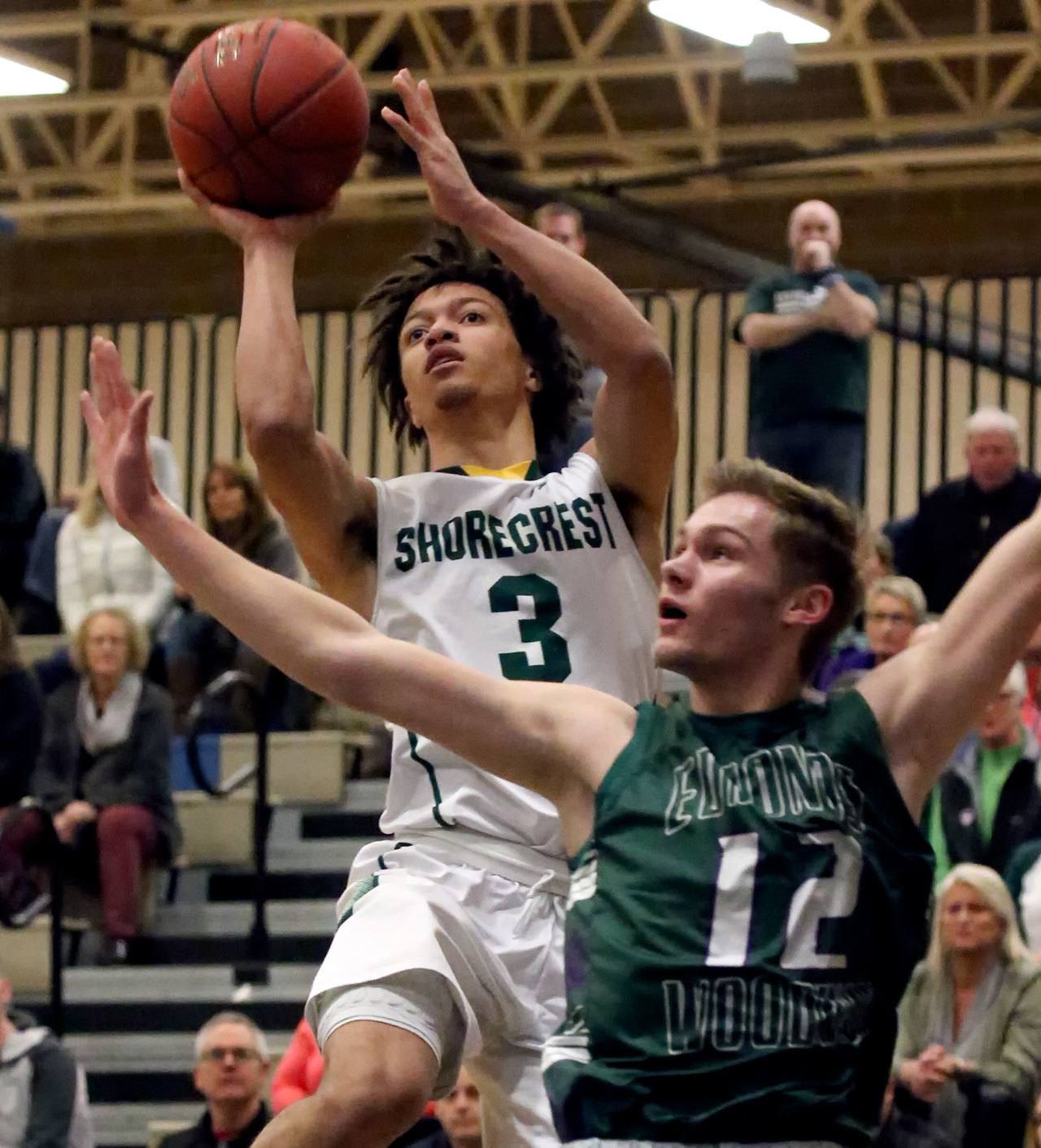 Shorecrest’s Malcolm Rosier-Butler attempts a shot with Edmonds-Woodway’s Noah Becker defending during a state regional playoff game on Feb. 25, 2017, at Bothell High School. Shorecrest won 74-63. (Kevin Clark / The Herald)
