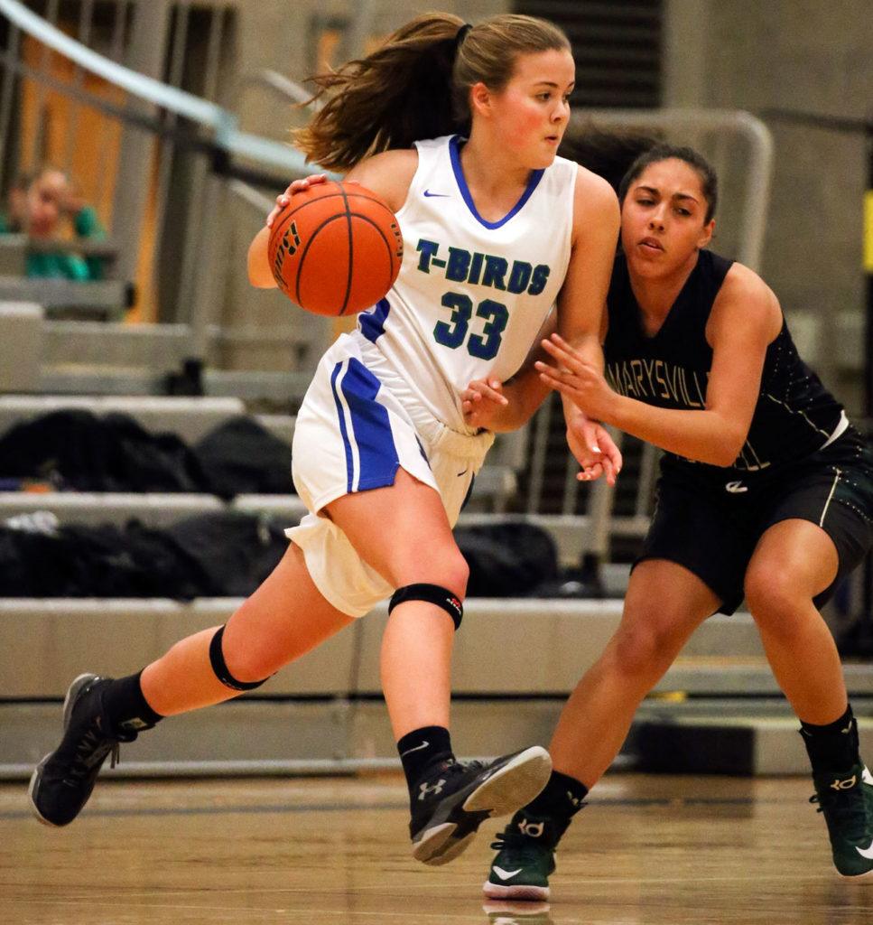 Shorewood’s Katie Taylor (left) dribbles the ball with Marysville Getchell’s Jadyn Noriega defending Friday night at Shorewood High in Shoreline. Shorewood won 43-35. (Kevin Clark / The Herald)
