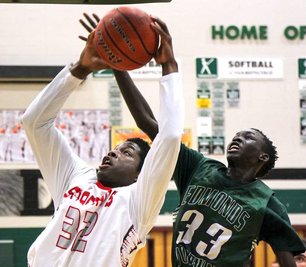 Stanwood’s Austin Wilhonen attempts a shot with Edmonds-Woodway’s Mutdung Bol defending Wednesday night at Henry M. Jackson in Everett on February 15, 2017. (Kevin Clark / The Herald)
