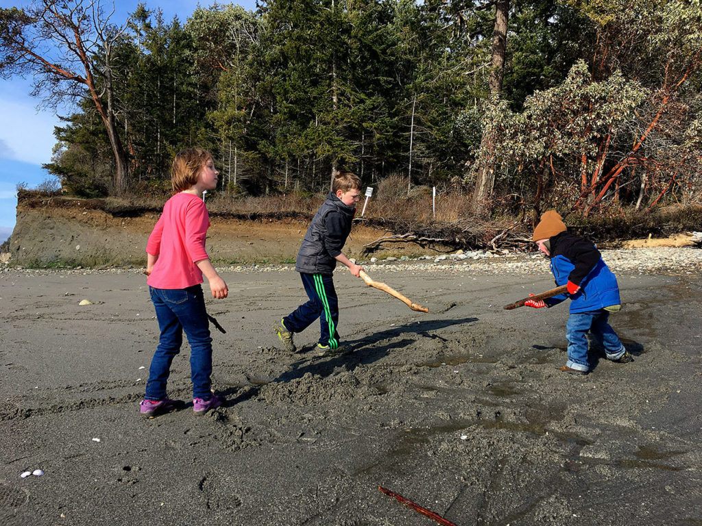 The Swaney kids play on the beach at Kitsap Memorial State Park like it was summer, even though its February. (Aaron Swaney / The Herald)
