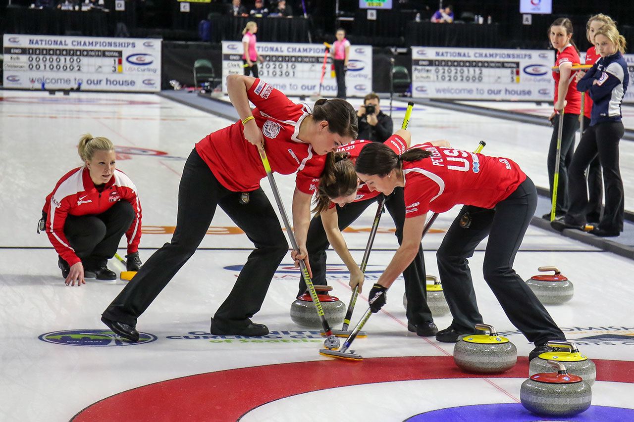 Members of Team Roth sweep a stone for better position Sunday night during the 2017 USA Curling Nationals at Xfinity Arena in Everett on February 12, 2017. (Kevin Clark / The Herald)                                Members of Team Roth sweep a stone for better position Sunday night during the 2017 USA Curling Nationals at Xfinity Arena in Everett. (Kevin Clark / The Herald)