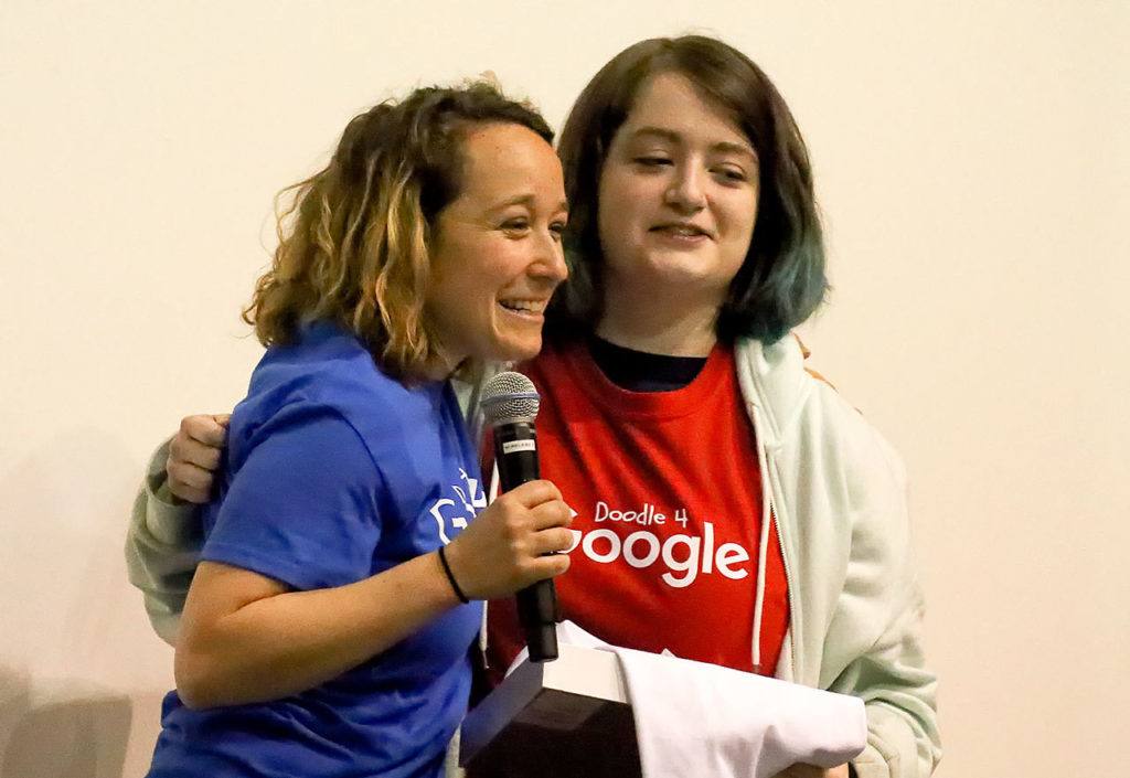 Nichol gives Marsh a hug during the assembly. (Kevin Clark / The Herald)
