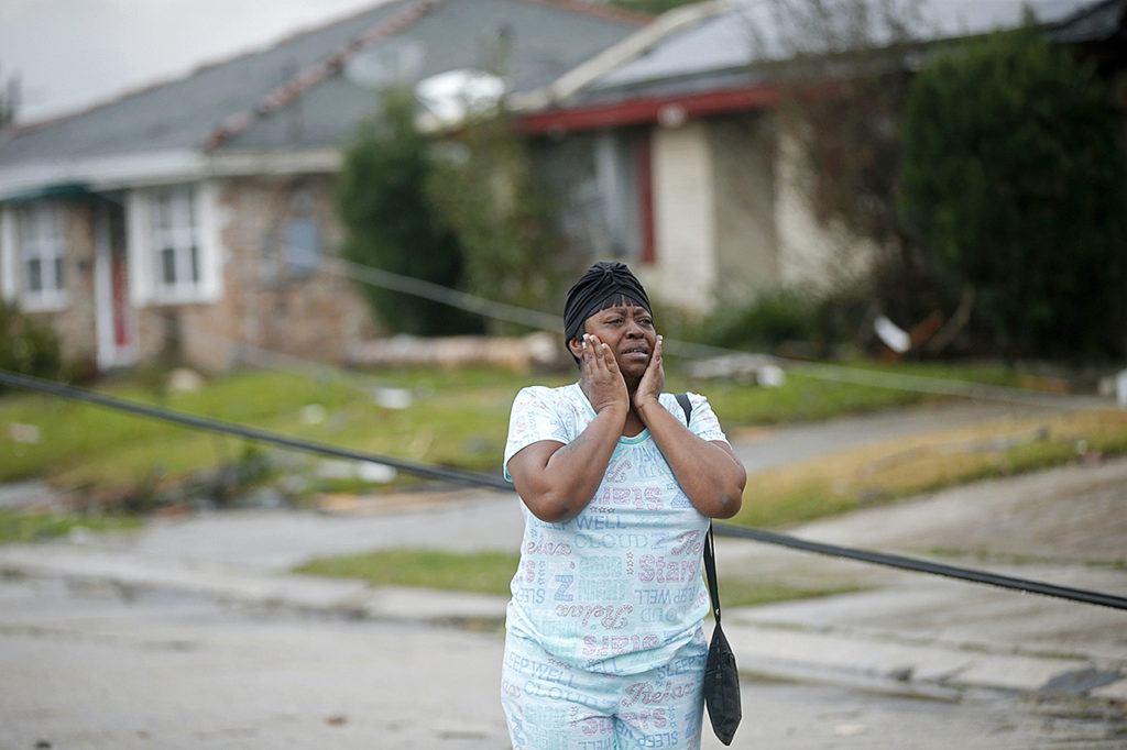 Lisa Carruth reacts as she surveys the damage after a tornado tore through the eastern part of New Orleans on Tuesday, Feb. 7. The National Weather Service says at least three confirmed tornadoes have touched down, including one inside the New Orleans city limits. Buildings have been damaged and power lines are down. (AP Photo/Gerald Herbert)
