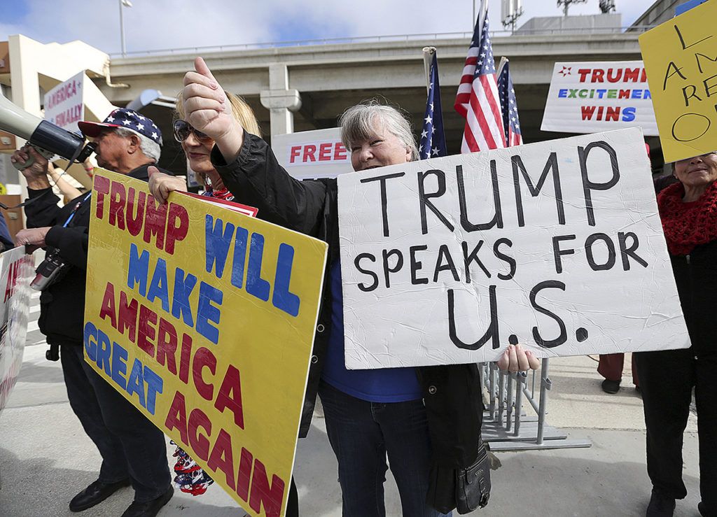 In this Feb. 4 photo, a woman gives a thumbs up in Los Angeles, California, as demonstrators in favor of President Donald Trump’s executive order banning travel to the U.S. from seven primarily Muslim nations stand across the street from the Tom Bradley International Terminal at Los Angeles International Airport. (AP Photo/Reed Saxon, File)
