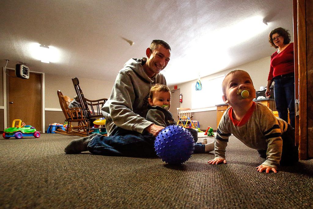 Volunteers like Andrew Nitchman, who has a 3-year-old and 6-year-old of his own, help out in the nursery. Children in the infant nursury are here until they walk. (Dan Bates / The Herald)
