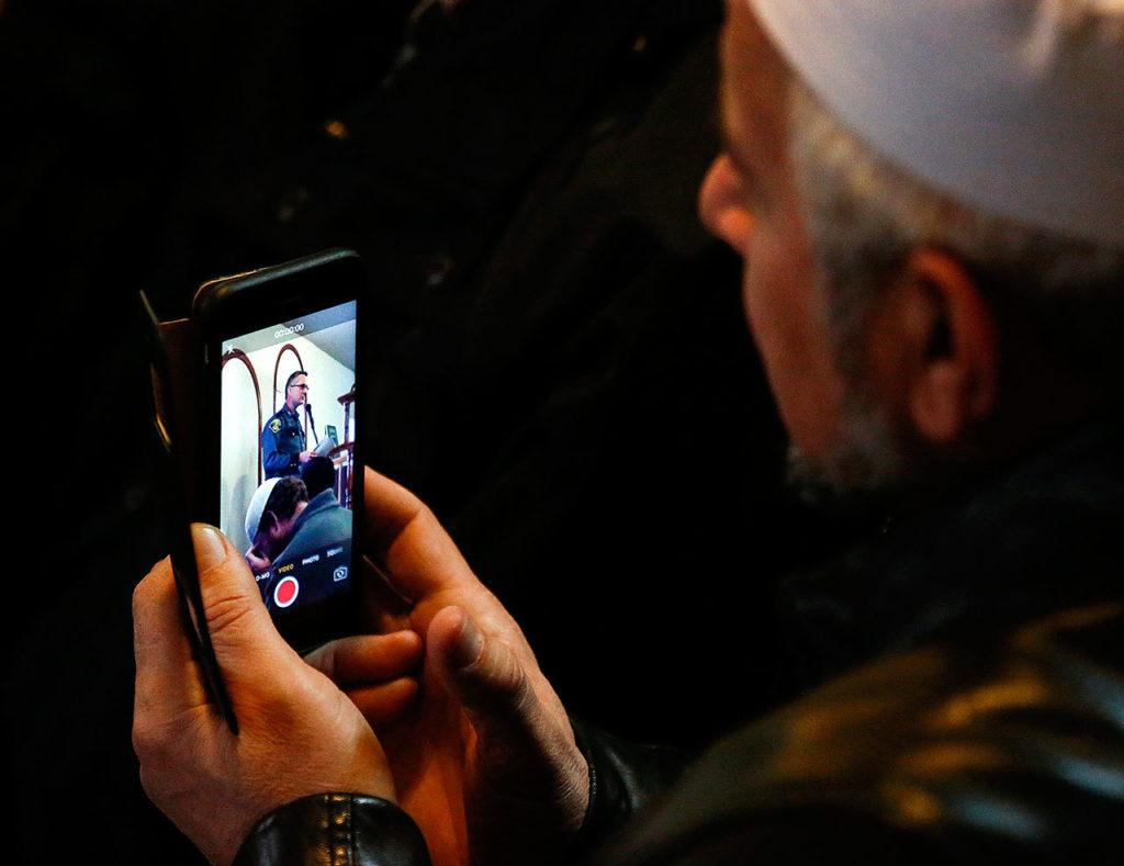 A member at the Evergreen Islamic Institute records Lynnwood Police Chief Tom Davis on his smartphone as he speaks to a standing room only crowd Friday. (Dan Bates / The Herald)

