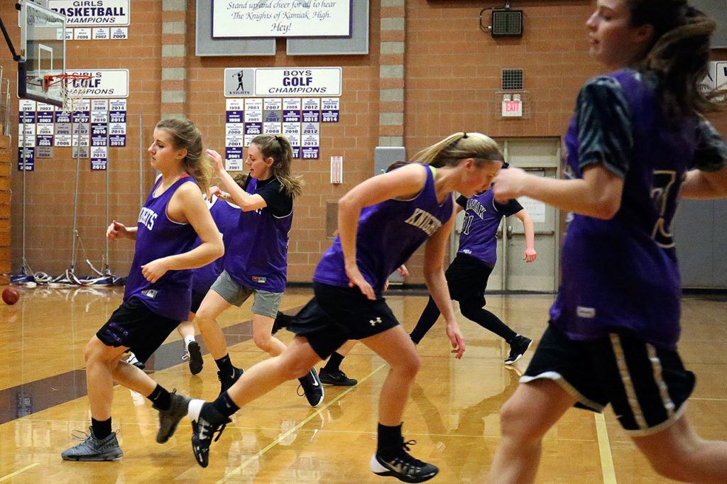 Kamiak players run lines to close practice on Feb. 23, 2017, at Kamiak High School in Mukilteo. (Kevin Clark / The Herald)
