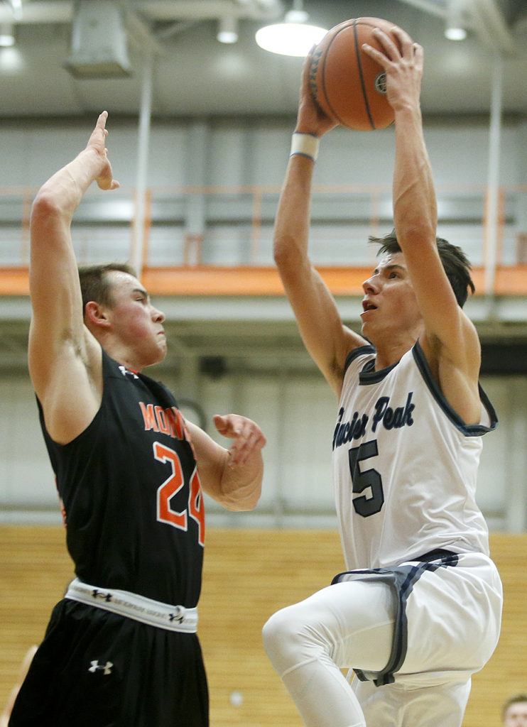 Glacier Peak’s Justin Purcell (right) goes up for a shot as Monroe’s Justin Folz defends during the Class 4A District 1 boys basketball championship game at Everett Community College on Thursday, Feb. 16. (Ian Terry / The Herald)
