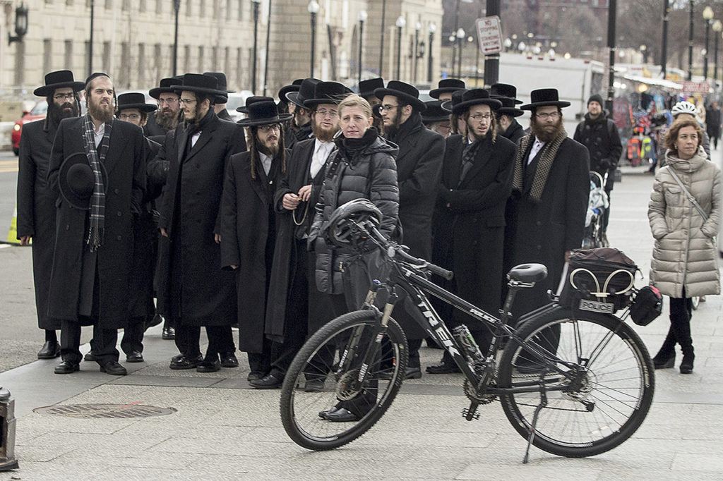 Orthodox Jews stand outside the White House in Washington on Wednesday, Feb. 15, as a motorcade carrying first lady Melania Trump and Sara Netanyahu, wife of Israeli Prime Minister Benjamin Netanyahu, passes them. (AP Photo/Andrew Harnik)
