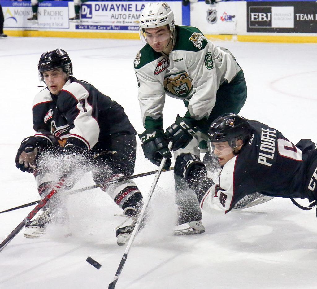 Vancouver’s Ty Ronning (L-R), Everett’s Patrick Bajkov and Vancouver’s Dylan Plouffe vie for control of the puck Saturday night at Xfinity Arena in Everett on February 4, 2017. (Kevin Clark / The Herald)

