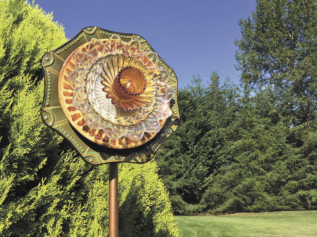 Glass flower sculpture displayed in a garden in Lake Stevens. (Lynn Jefferson / The Herald)